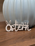 Schriftzug ,,Bunte Ostern'' mit Hasenohren
